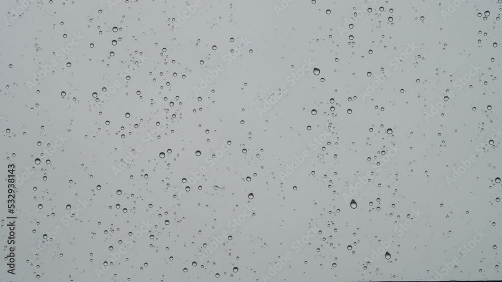 Real background of rain hitting glass with protective coating