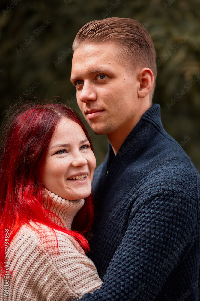 Loving couple of young people having fun on nature, young girl with red hair Loving couple of young people having fun on nature, young girl with red hair