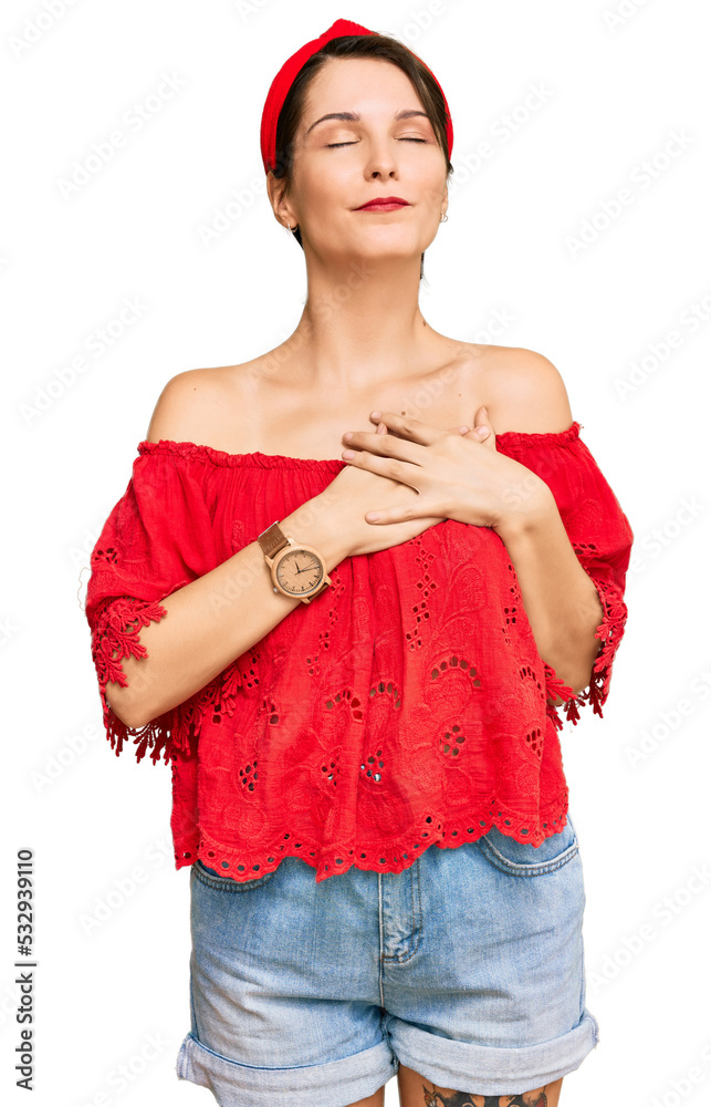 Young brunette woman with short hair wearing casual summer clothes and diadem smiling with hands on chest with closed eyes and grateful gesture on face. health concept. Young brunette woman with short hair wearing casual summer clothes and diadem smiling with hands on chest with closed eyes and grateful gesture on face. health concept.