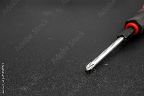 Obraz na plátně Isolated screwdriver on a black background