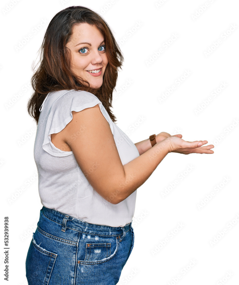 Young plus size woman wearing casual white t shirt pointing aside with hands open palms showing copy space, presenting advertisement smiling excited happy Young plus size woman wearing casual white t shirt pointing aside with hands open palms showing copy space, presenting advertisement smiling excited happy
