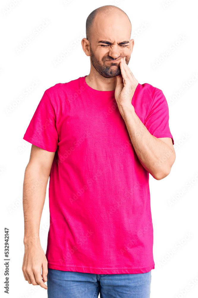 Young handsome man wearing casual t shirt touching mouth with hand with painful expression because of toothache or dental illness on teeth. dentist Young handsome man wearing casual t shirt touching mouth with hand with painful expression because of toothache or dental illness on teeth. dentist