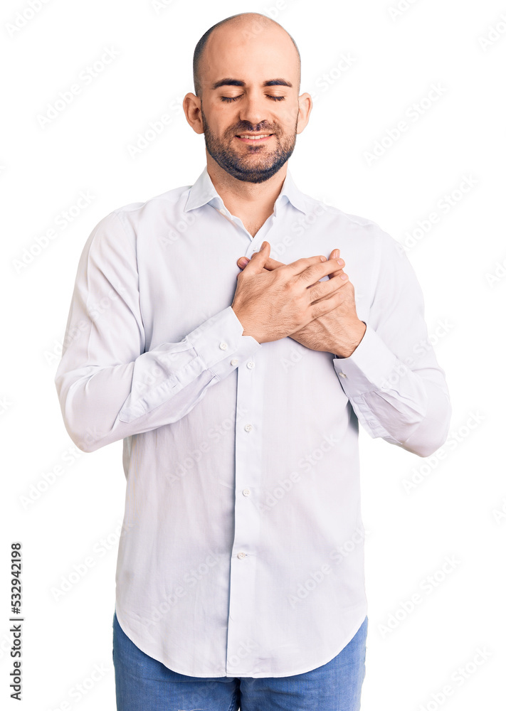 Young handsome man wearing elegant shirt smiling with hands on chest with closed eyes and grateful gesture on face. health concept. Young handsome man wearing elegant shirt smiling with hands on chest with closed eyes and grateful gesture on face. health concept.