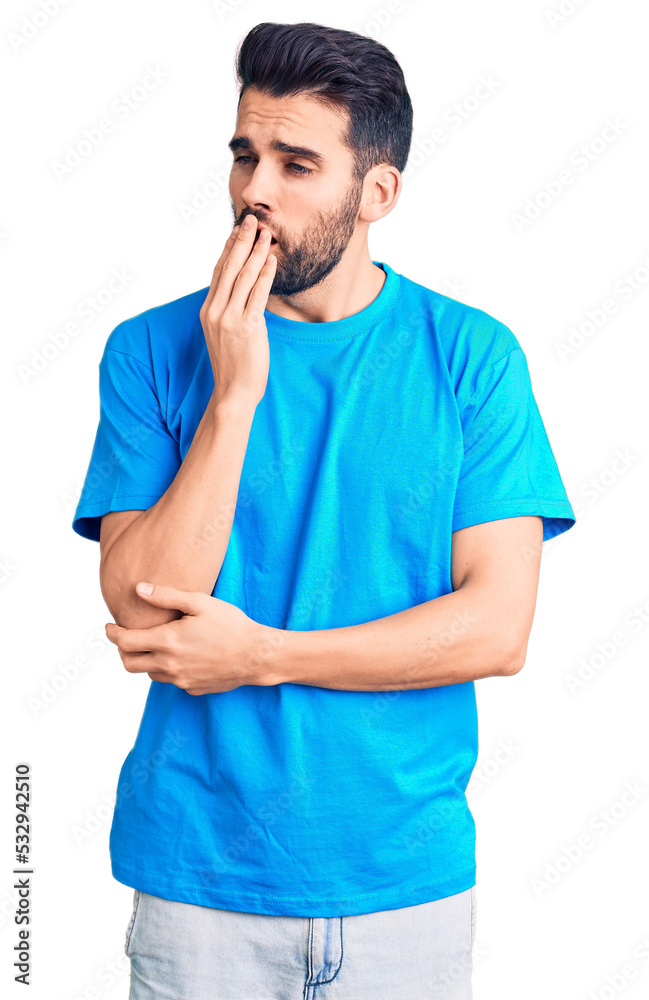 Young handsome man with beard wearing casual t-shirt bored yawning tired covering mouth with hand. restless and sleepiness. Young handsome man with beard wearing casual t-shirt bored yawning tired covering mouth with hand. restless and sleepiness.
