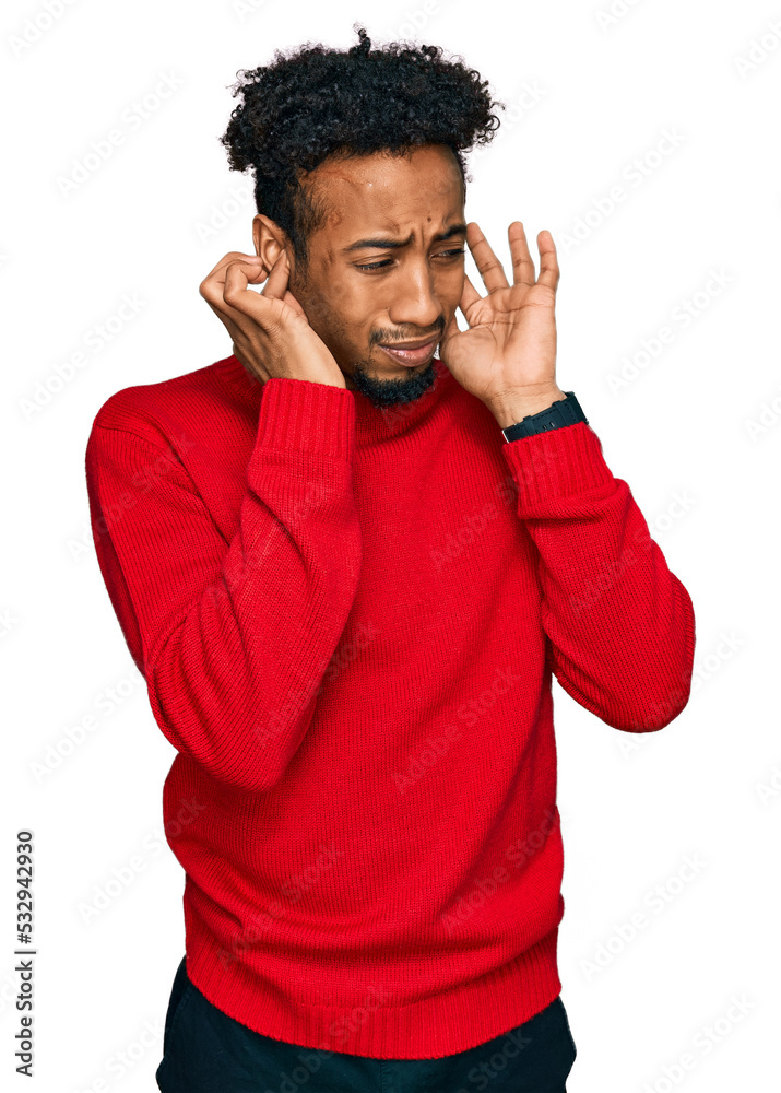 Young african american man with beard wearing casual winter sweater covering ears with fingers with annoyed expression for the noise of loud music. deaf concept. Young african american man with beard wearing casual winter sweater covering ears with fingers with annoyed expression for the noise of loud music. deaf concept.