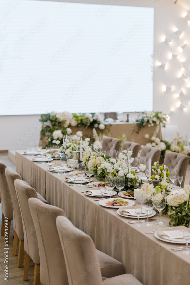 Tables setting at a luxury wedding. Table for guests. Dishes and drinks. Wedding table preparation.