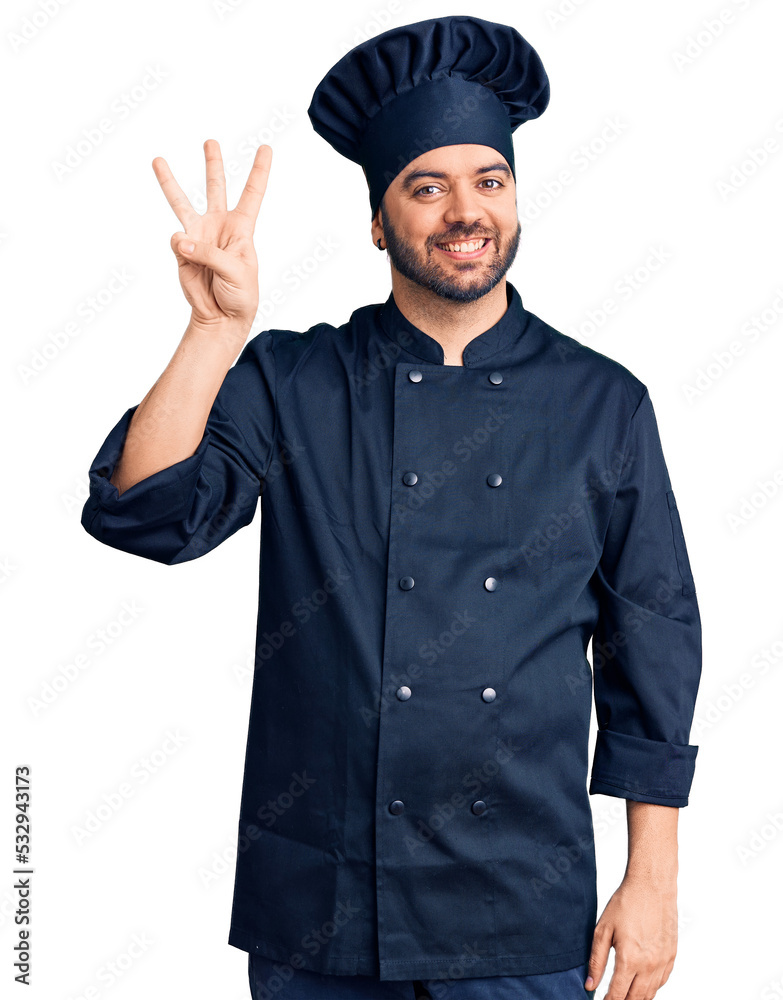 Young hispanic man wearing cooker uniform showing and pointing up with fingers number three while smiling confident and happy. Young hispanic man wearing cooker uniform showing and pointing up with fingers number three while smiling confident and happy.