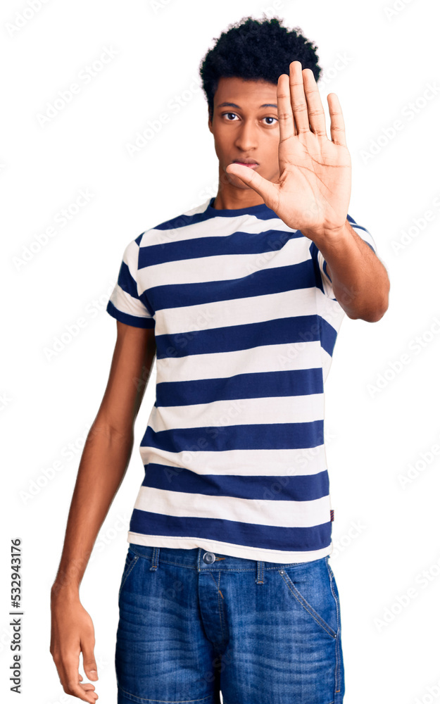 Young african american man wearing casual clothes doing stop sing with palm of the hand. warning expression with negative and serious gesture on the face. Young african american man wearing casual clothes doing stop sing with palm of the hand. warning expression with negative and serious gesture on the face.