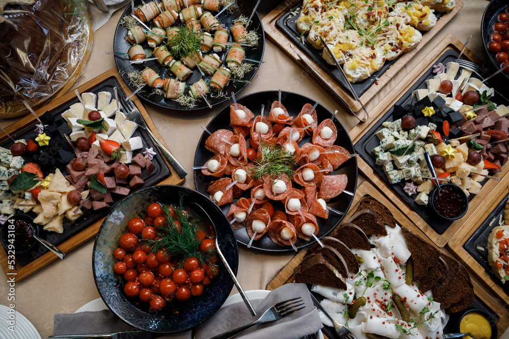 Buffet table with food and snacks for the guests of the event. Service ...