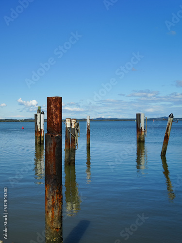 Rusted and weathered bollards in the sea at Redland Bay, Queensland, Australia 