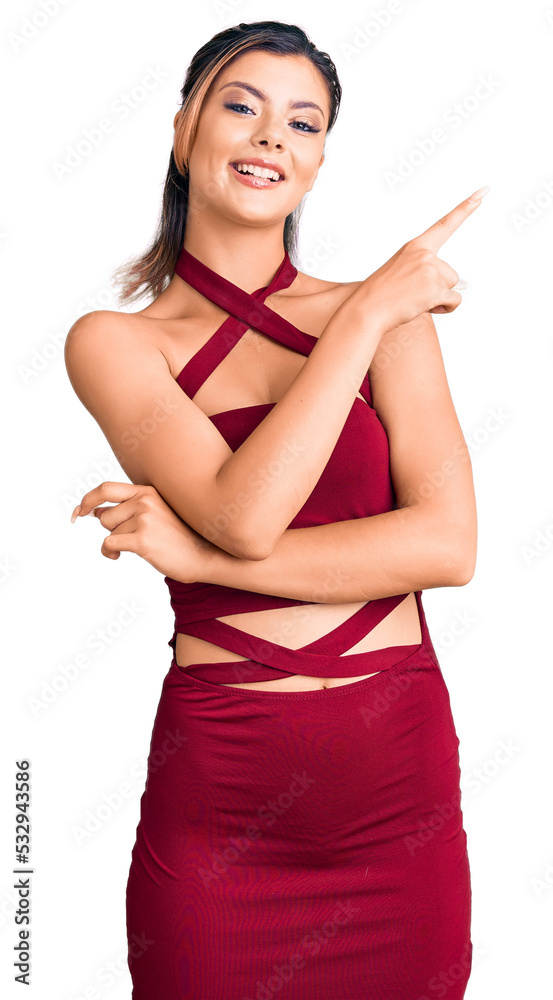 Young beautiful woman wearing casual clothes with a big smile on face, pointing with hand and finger to the side looking at the camera. Young beautiful woman wearing casual clothes with a big smile on face, pointing with hand and finger to the side looking at the camera.