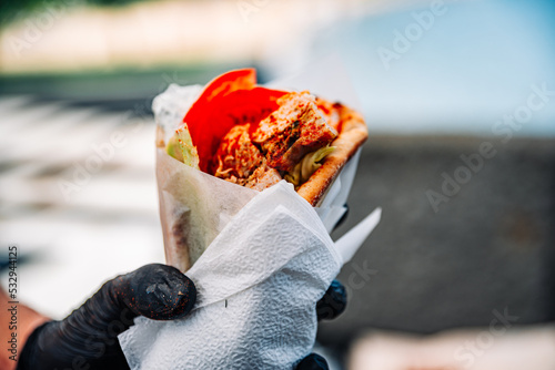 Greek street food gyros in man hand outdoor photo