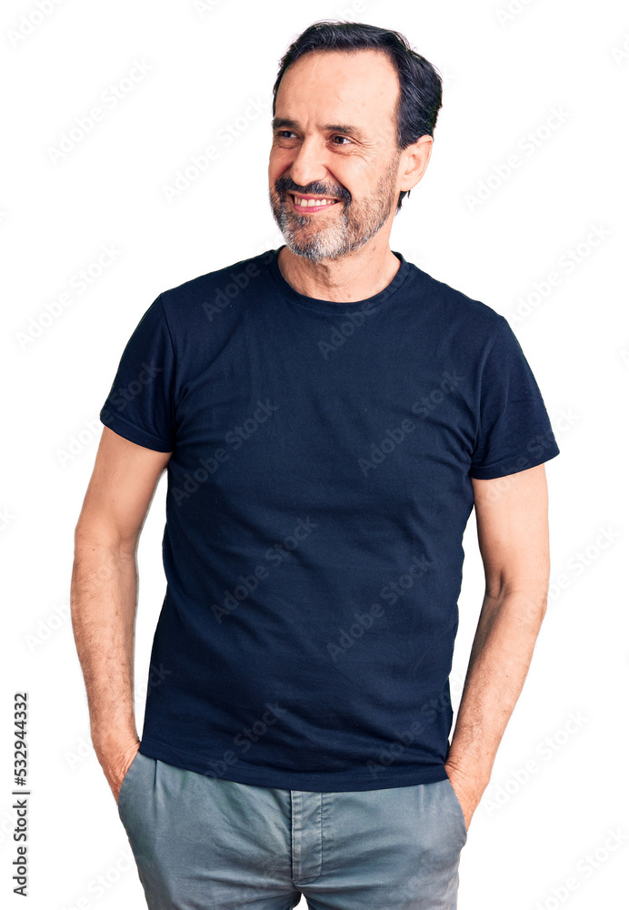 Middle age handsome man wearing casual t-shirt looking away to side with smile on face, natural expression. laughing confident. Middle age handsome man wearing casual t-shirt looking away to side with smile on face, natural expression. laughing confident.