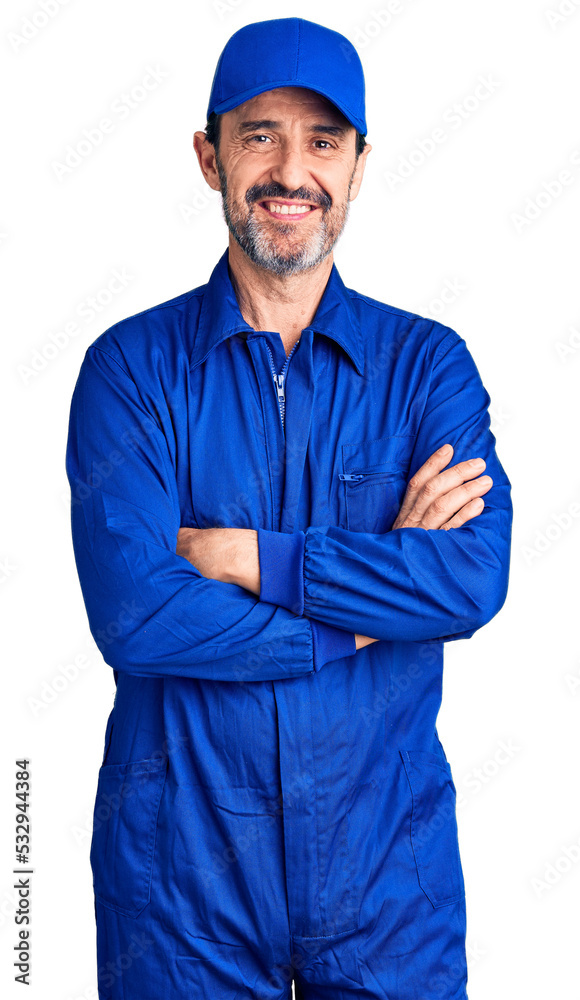Middle age handsome man wearing mechanic uniform happy face smiling with crossed arms looking at the camera. positive person. Middle age handsome man wearing mechanic uniform happy face smiling with crossed arms looking at the camera. positive person.