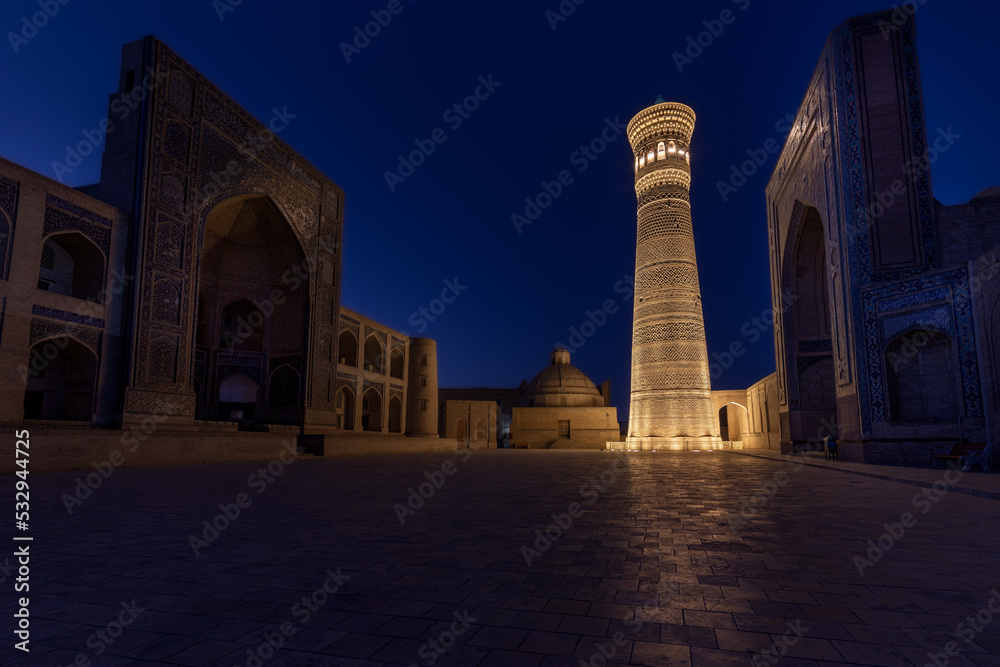 Poi-Kalyan square at night with brightly illuminated Kalyan minaret, Bukhara, Uzbekistan