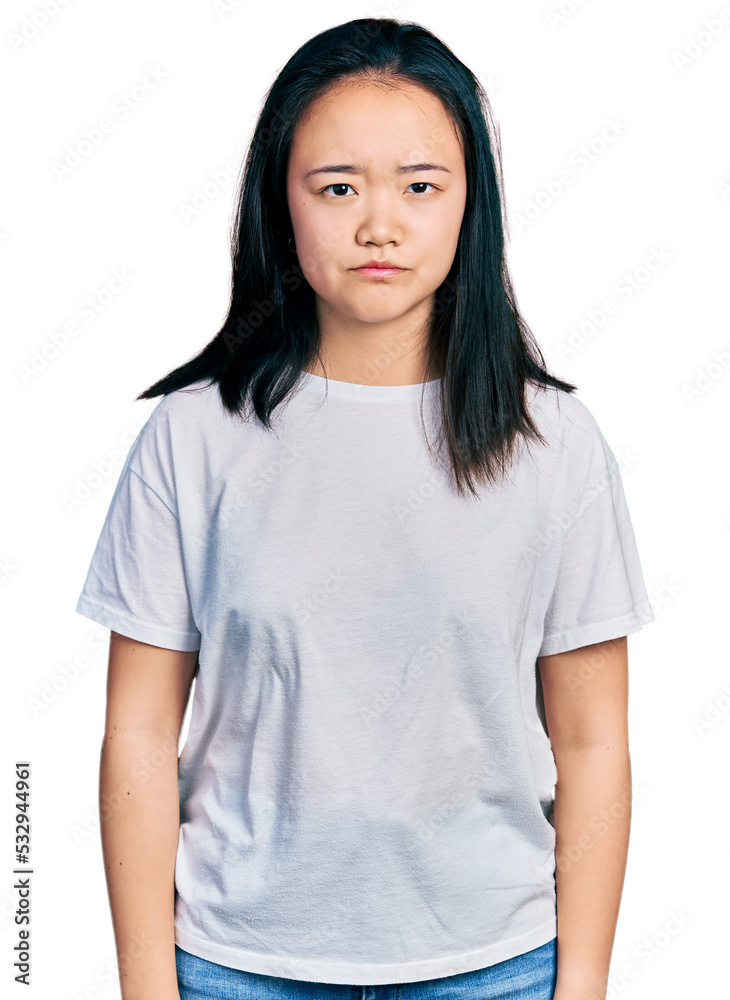 Young chinese woman wearing casual white t shirt skeptic and nervous, frowning upset because of problem. negative person. Young chinese woman wearing casual white t shirt skeptic and nervous, frowning upset because of problem. negative person.