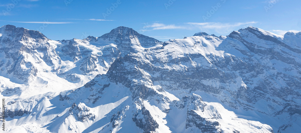 The Panoramic of Swiss Mountain against the blue sky background The Panoramic of Swiss Mountain against the blue sky background