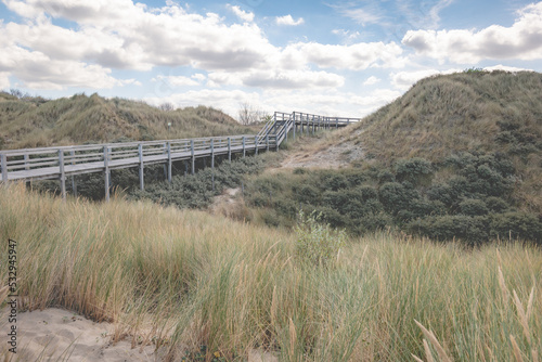 wooden bridge over the dune and sand