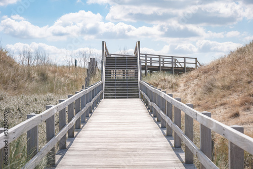 wooden bridge over the dune and sand