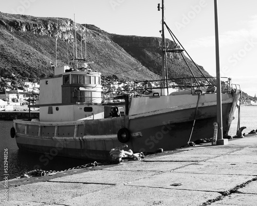 Boat docked in harbour in the morning