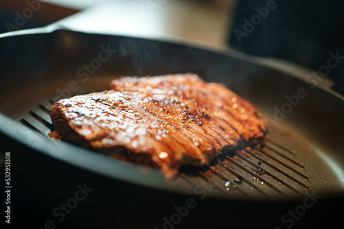 Beef entrecote is fried in a pan.