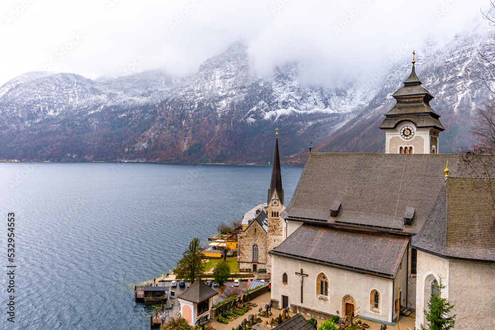 Pfarrkirche Maria Himmelfahrt , Gothic church in Hallstatt , Romance town at Lake Hallstatt  during winter cloudy day : Hallstatt , Austria : December 10 , 2019