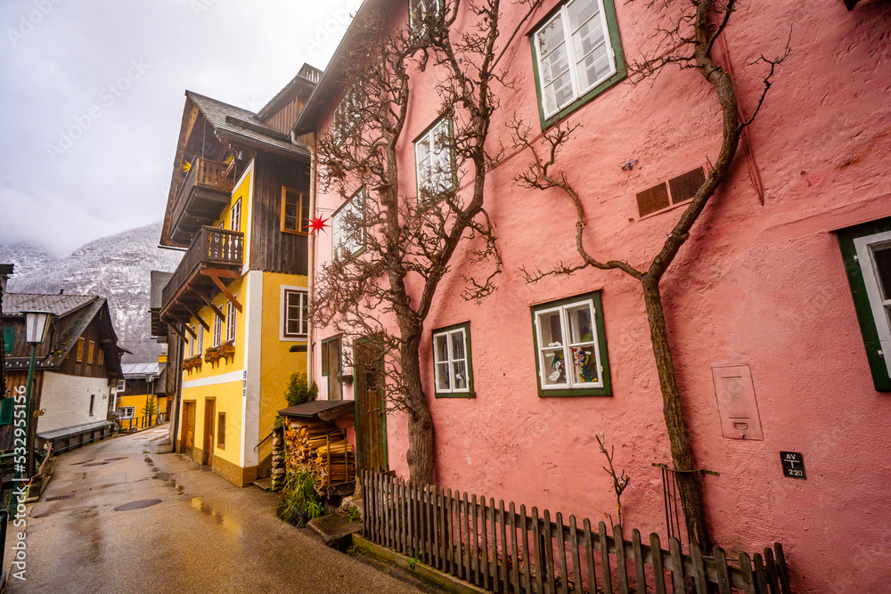 Colourful houses and decorate buildings in Hallstatt , Romance town at Lake Hallstatt  during winter cloudy day : Hallstatt , Austria : December 10 , 2019