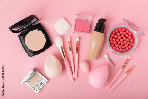 Makeup accessories,beauty blender and makeup brushes.Powder,foundation,eyeshadow and blush on pink texture background.beauty and fashion. Beauty concept