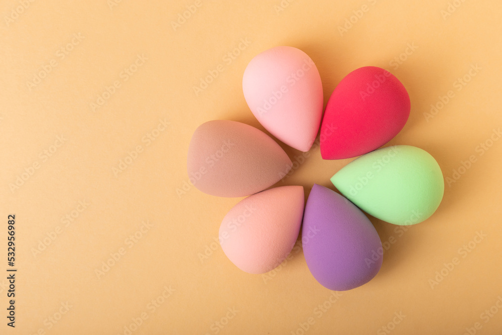 Beauty blender.Colorful beauty sponges on a beige background. Cosmetic tool for applying and blending products such as foundation and concealer. Copy space. place for text.