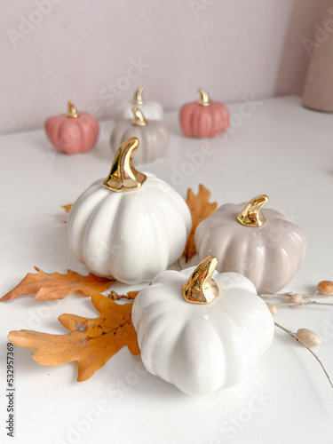 Collection of handmade ceramic pumkins. Autumn seasonal holidays background in white colors. Frame, space for text. Close up. Thanksgiving, fall decoration. Mockup of empty frame with pumpkin decor