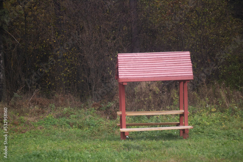 Bench in park. Place to relax in forest. Infrastructure of hiking trail.