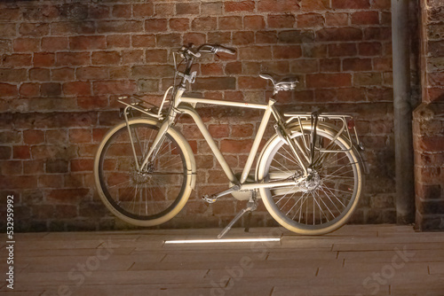 old bicycle on the street in the evening with light