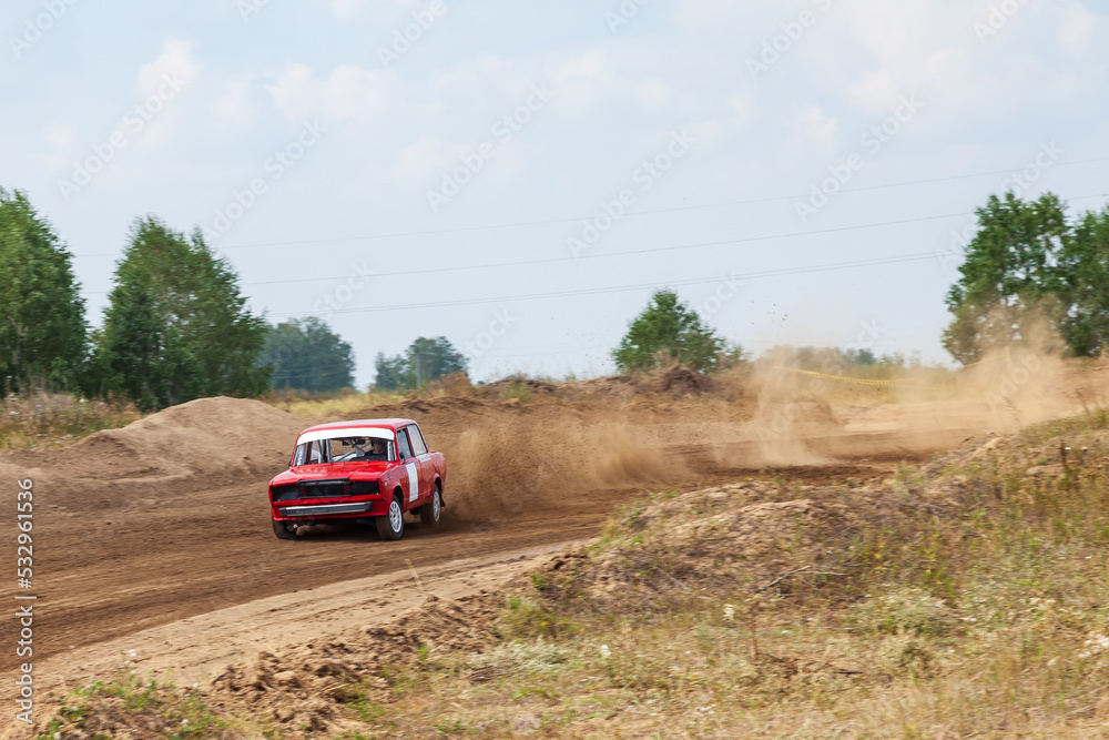Rally off-road car make a turn with the clouds and splashes of sand, gravel and dust during rally championship Rally off-road car make a turn with the clouds and splashes of sand, gravel and dust during rally championship