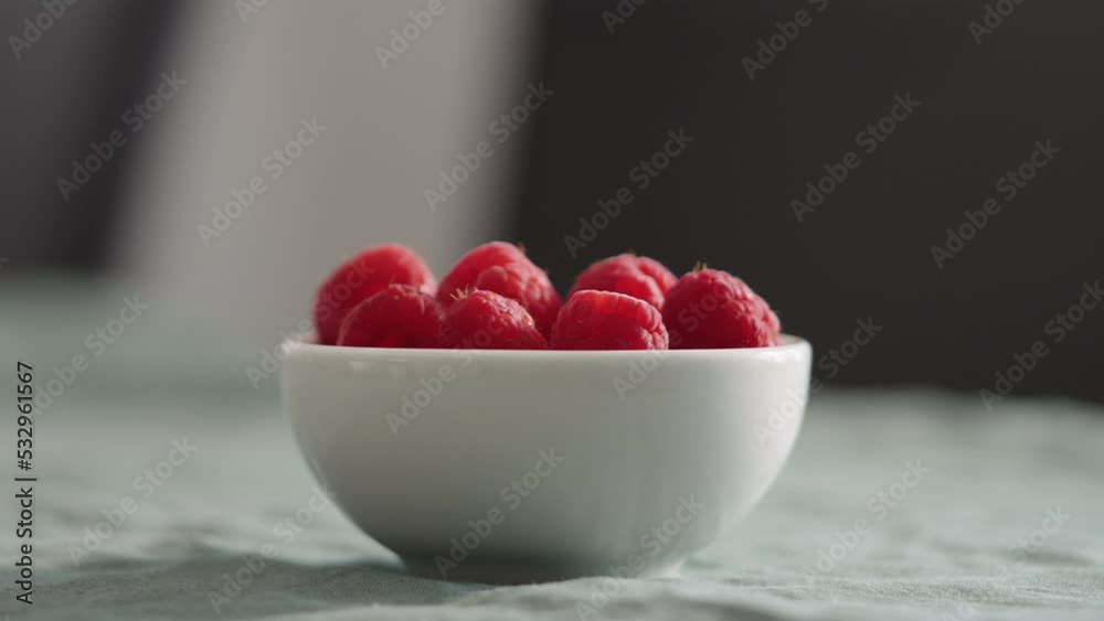 Fresh raspberries in bowl on linen napkin Fresh raspberries in bowl on linen napkin