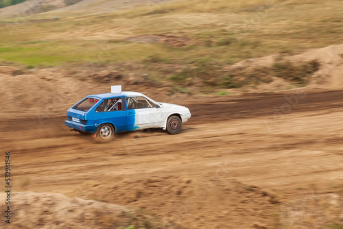 Rally off-road car make a turn with the clouds and splashes of sand  gravel and dust during rally championship