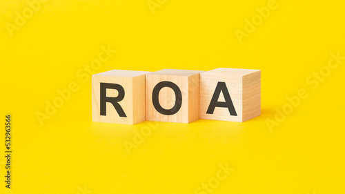 text roa on wood blocks, yellow background photo