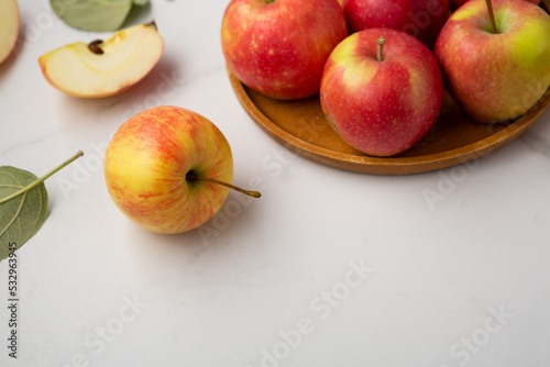 Close up of red yellow apples on wooden plate fruits food copy space