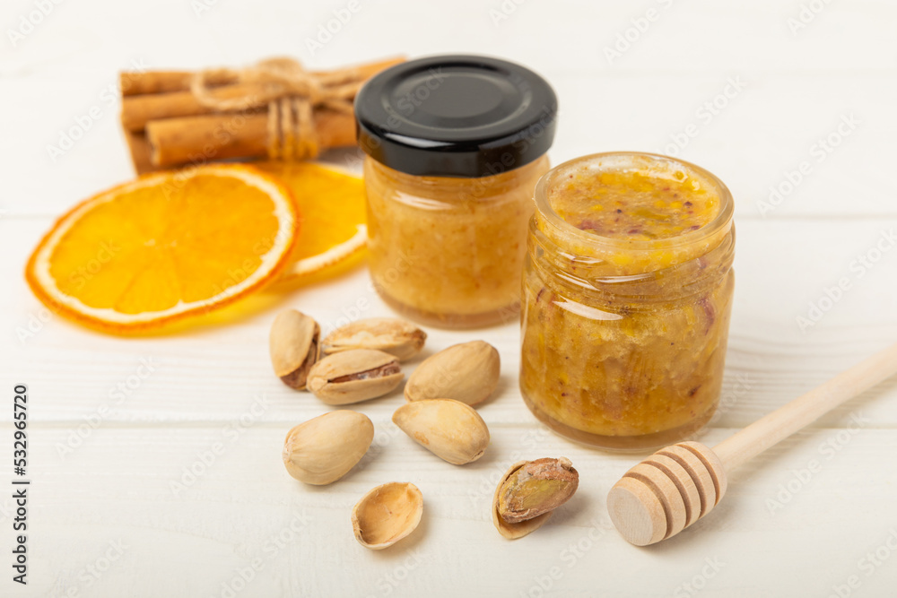 Pistachio honey on white texture wood. Assorted honey. Honey in pistachios and almonds. Environmentally friendly product. Vitaminized jam. Cold remedy.Copy space Pistachio honey on white texture wood. Assorted honey. Honey in pistachios and almonds. Environmentally friendly product. Vitaminized jam. Cold remedy.Copy space