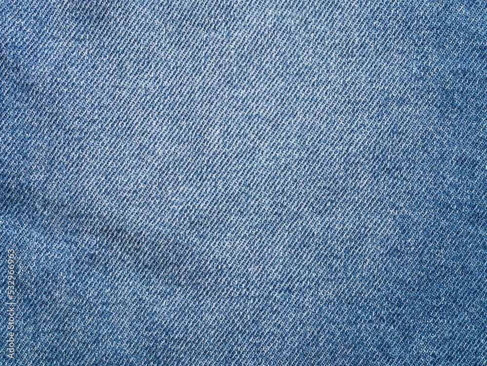 Denim fabric texture of a piece of cloth. Empty background of a textile material. Clothing part in a close-up view. Abstract backdrop of woven fibers. Blue jeans cloth pattern structure. Denim fabric texture of a piece of cloth. Empty background of a textile material. Clothing part in a close-up view. Abstract backdrop of woven fibers. Blue jeans cloth pattern structure.