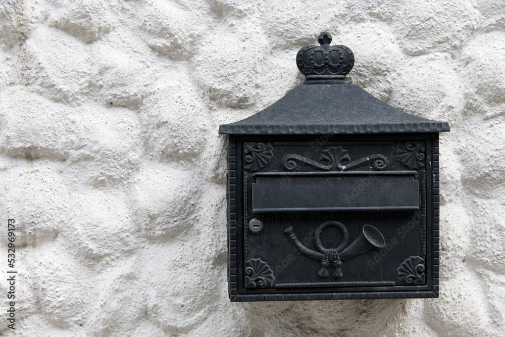 Closeup house facade black ornate wrought mailbox