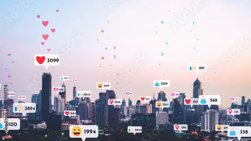 Social media icons fly over city downtown showing people reciprocity connection through social network application platform . Concept for online community and social media marketing strategy . photo
