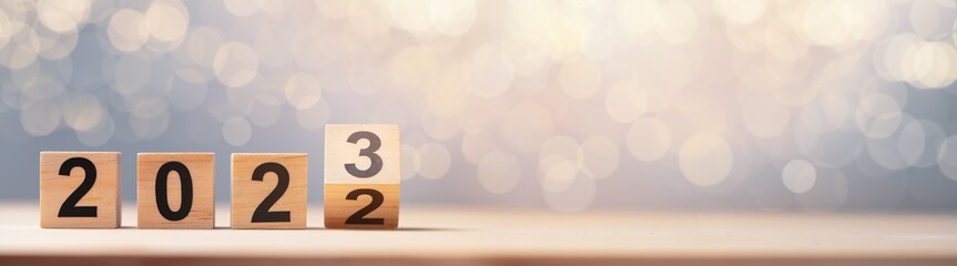 Cube turns from 2022 to 2023 on wooden table