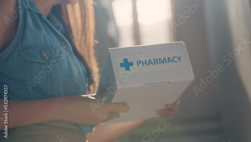Asia female people smile free help first aid Rx kit carton box at home front door. Clinic drug store send self cure mail post parcel to young woman online health care happy order herbal vitamin postal