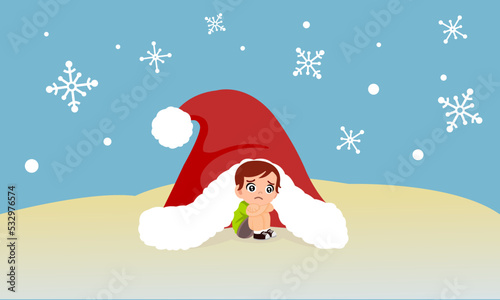 Little boy sitting alone in a big Santa Claus hat shielding the cold from the snow.Loneliness on Christmas New Year. Waiting for presents from Santa Claus.