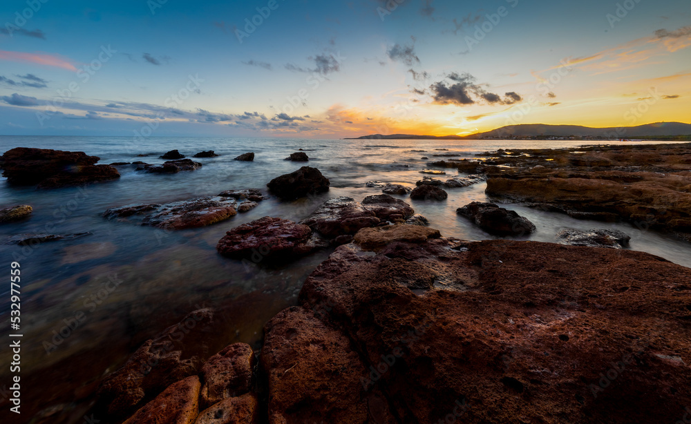 Rocky shore in Alghero at sunset
