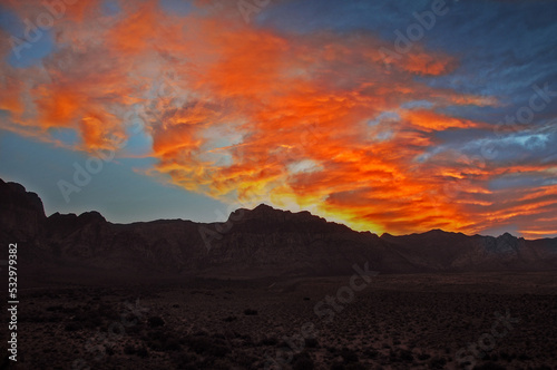 Red Orange Sunset Fire Clouds in Sky above Mountain Range 