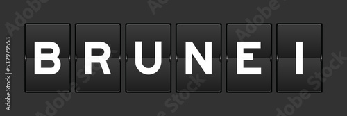 Black color analog flip board with word brunei on gray background