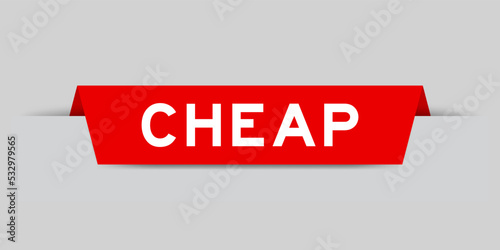 Red color inserted label with word cheap on gray background