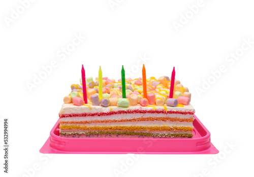 birthday cake with candles
multi-colored rainbow cake in a transparent box with a red bow. Celebration cake with five candles isolated on white background.