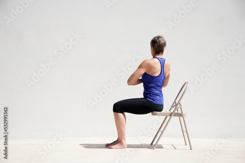 Middle aged senior yoga woman demonstrating asana for aging bodies. 